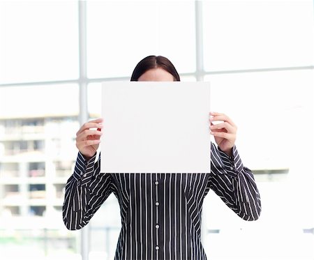 simsearch:400-04648812,k - Smiling woman showing a big business card in front of her head in office Stock Photo - Budget Royalty-Free & Subscription, Code: 400-04123038