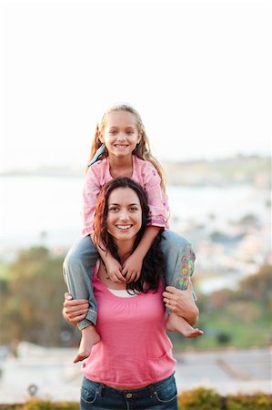 simsearch:400-04612785,k - Portrait of smiling mother giving piggyback ride to child Stock Photo - Budget Royalty-Free & Subscription, Code: 400-04123051