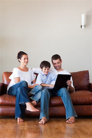simsearch:400-04575374,k - Parents and son playing with a laptop at home with copy-space Stock Photo - Budget Royalty-Free & Subscription, Code: 400-04123078