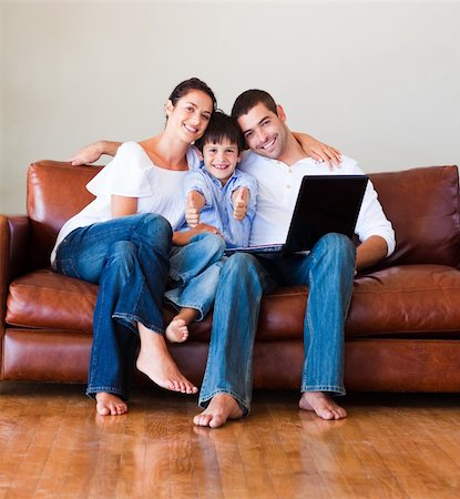 study online at home - Young family using a labtop on sofa in living-room Stock Photo - Budget Royalty-Free & Subscription, Code: 400-04123080