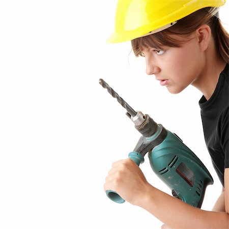 Young woman builder in yellow helmet holding driller Stock Photo - Budget Royalty-Free & Subscription, Code: 400-04123274