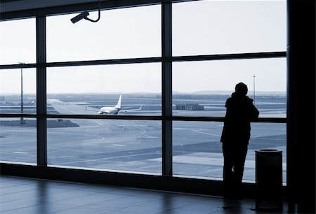 people airports silhouettes - Airport lounge or waiting area with business man standing looking outside of window towards control tower Stock Photo - Budget Royalty-Free & Subscription, Code: 400-04134746