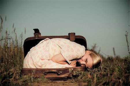 people lying down on the road - Happy woman lies in a suitcase outdoors. Stock Photo - Budget Royalty-Free & Subscription, Code: 400-04136084