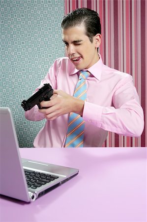 businessman young shooting handgun with computer pink bacground Stock Photo - Budget Royalty-Free & Subscription, Code: 400-04136338