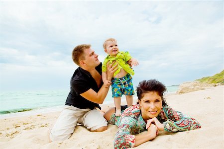 simsearch:400-05291156,k - Mom, son and dad having fun on the seashore Stock Photo - Budget Royalty-Free & Subscription, Code: 400-04136785