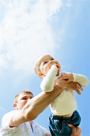 simsearch:400-04221909,k - Baby boy flying on his dad's hands Fotografie stock - Microstock e Abbonamento, Codice: 400-04136844