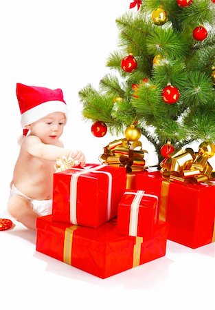 Baby unpacking Christmas presents, isolated Stock Photo - Budget Royalty-Free & Subscription, Code: 400-04136848