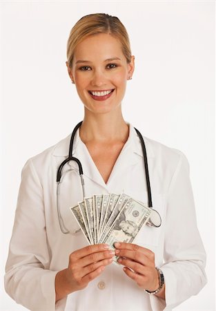 simsearch:400-04758612,k - smiling female doctor fanning out one hundred and twenty dollar bills Stock Photo - Budget Royalty-Free & Subscription, Code: 400-04137275