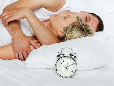 simsearch:400-04287303,k - Young couple in bed with focus in alarm clock Stock Photo - Budget Royalty-Free & Subscription, Code: 400-04138192