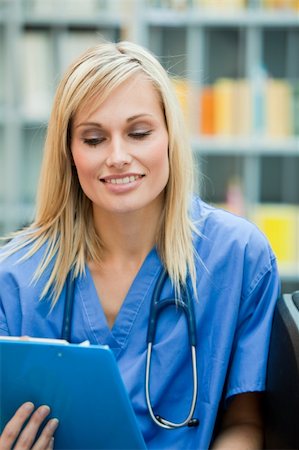 simsearch:400-04704005,k - Young blond doctor reading a report in hospital Stock Photo - Budget Royalty-Free & Subscription, Code: 400-04138313