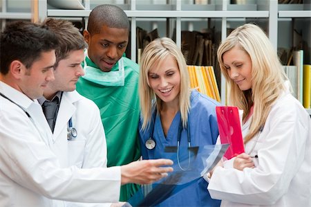 doctor patient laughing not kids - Group of doctors speaking in a hospital office and smiling Stock Photo - Budget Royalty-Free & Subscription, Code: 400-04138322