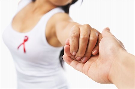 simsearch:400-05701644,k - Woman holding hand to give support for AIDS cause or breast cancer, using red ribbon badge on her chest. PS: you can change the ribbon color to pink for breast cancer support cause as both using the same symbol Stock Photo - Budget Royalty-Free & Subscription, Code: 400-04138629