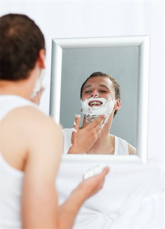 Happy young man shaving in bathroom Stock Photo - Budget Royalty-Free & Subscription, Code: 400-04139556