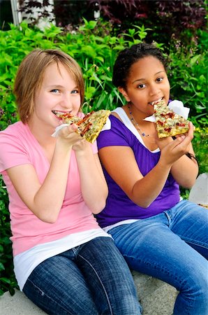 Two teenage girls sitting and eating pizza Stock Photo - Budget Royalty-Free & Subscription, Code: 400-04130244