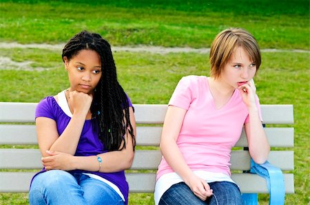 Two bored teenage girls sitting on bench Stock Photo - Budget Royalty-Free & Subscription, Code: 400-04130250