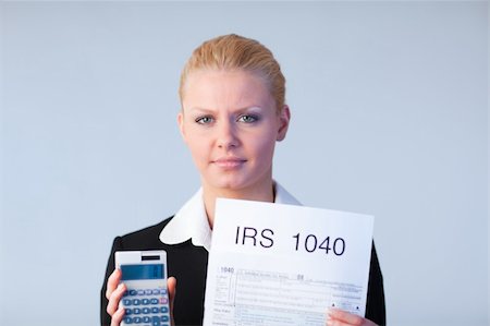 simsearch:400-05339747,k - Business woman looking at filling in tax returns Stock Photo - Budget Royalty-Free & Subscription, Code: 400-04130511