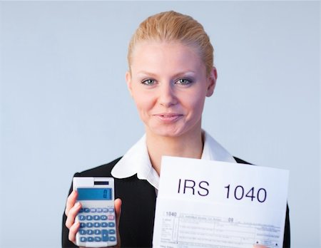 simsearch:400-05339747,k - Business woman looking at filling in tax returns Stock Photo - Budget Royalty-Free & Subscription, Code: 400-04130512