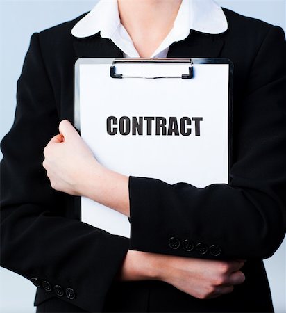 simsearch:400-05895521,k - Young Woman holding a contract on a clipboard Stock Photo - Budget Royalty-Free & Subscription, Code: 400-04130524
