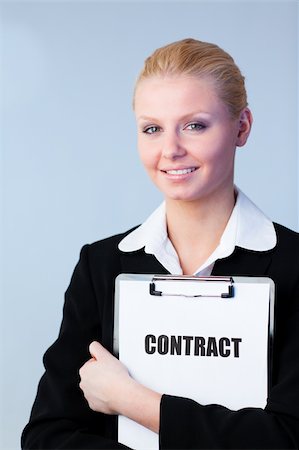 simsearch:400-05895521,k - Young Woman holding a contract on a clipboard Stock Photo - Budget Royalty-Free & Subscription, Code: 400-04130523