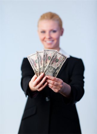 simsearch:400-05156727,k - Business woman holding up dollars with camera focus on the dollars Foto de stock - Super Valor sin royalties y Suscripción, Código: 400-04130534