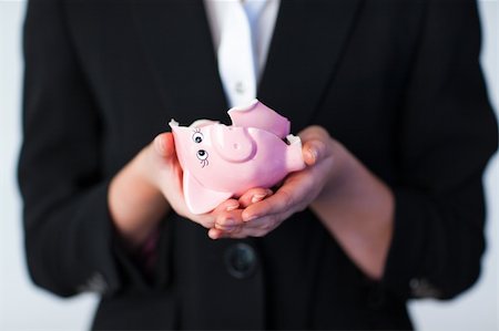 downturn - Young Business woman holding a broken piggy bank Stock Photo - Budget Royalty-Free & Subscription, Code: 400-04130625