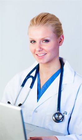 doctor business computer - Young Doctor working on a laptop looking at camera Stock Photo - Budget Royalty-Free & Subscription, Code: 400-04130788
