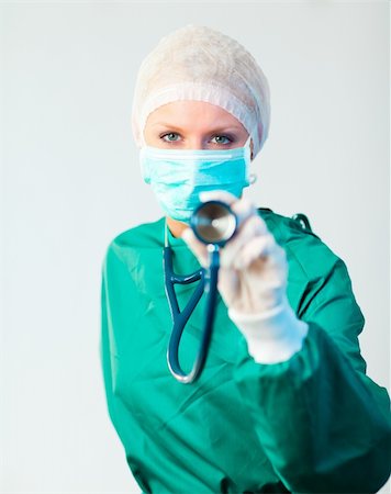 simsearch:400-06634198,k - Young female Surgeon holding stethescope outwards Stock Photo - Budget Royalty-Free & Subscription, Code: 400-04130927