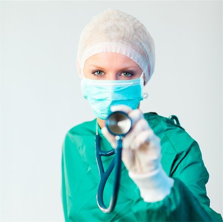 simsearch:400-06634198,k - Young female Surgeon holding stethescope outwards Stock Photo - Budget Royalty-Free & Subscription, Code: 400-04130928