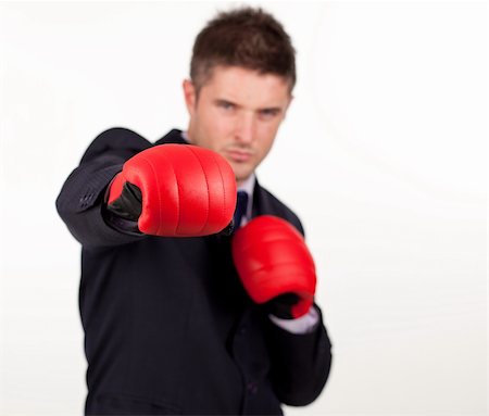 simsearch:400-04131234,k - Jeune homme d'affaires attrayant avec des gants de boxe et de se concentrer sur les gants Photographie de stock - Aubaine LD & Abonnement, Code: 400-04131233