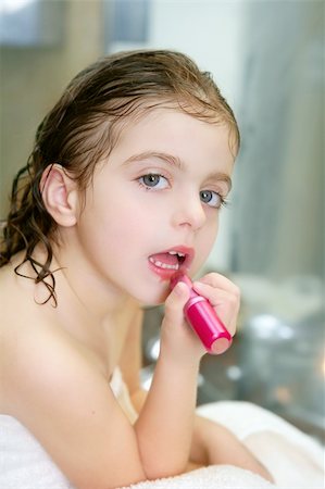 Little girl playing with lipstick makeup on the bathroom Stock Photo - Budget Royalty-Free & Subscription, Code: 400-04131886