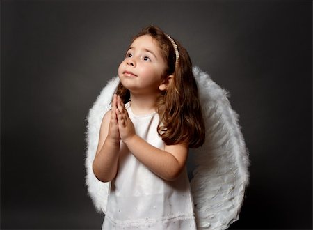 Little white angel child with hands together in devotional prayer and looking heavenward with hope and faith. Stock Photo - Budget Royalty-Free & Subscription, Code: 400-04132174