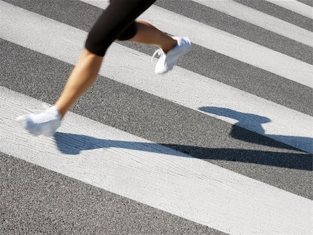 cropped view of female runner crossing street. Copy space Stock Photo - Budget Royalty-Free & Subscription, Code: 400-04132424