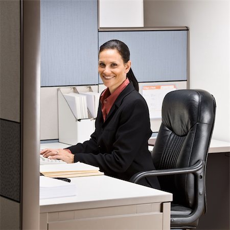 simsearch:400-04129016,k - Businesswoman sitting at desk smiling Stock Photo - Budget Royalty-Free & Subscription, Code: 400-04132729
