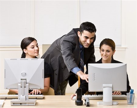 enterprise computer - Businessman helping co-worker with work Stock Photo - Budget Royalty-Free & Subscription, Code: 400-04132774