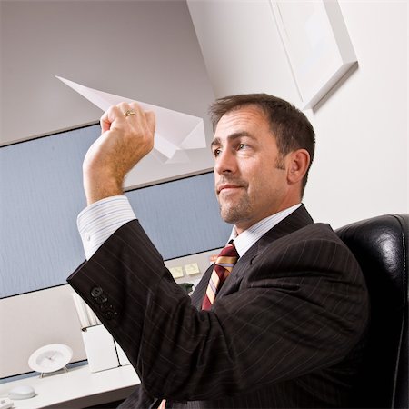 Businessman throwing paper airplane Stock Photo - Budget Royalty-Free & Subscription, Code: 400-04132808