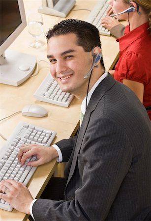 simsearch:400-04129016,k - Businessman talking on headsets Stock Photo - Budget Royalty-Free & Subscription, Code: 400-04132893