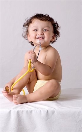 simsearch:400-06416929,k - Child at the doctor.Looks at a stethoscope. Stock Photo - Budget Royalty-Free & Subscription, Code: 400-04132971