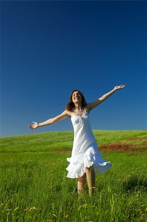Beautiful happy young woman dancing on the field Stock Photo - Budget Royalty-Free & Subscription, Code: 400-04133090
