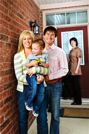 family with sold sign - Real estate agent with family welcoming to new home Stock Photo - Budget Royalty-Free & Subscription, Code: 400-04133262
