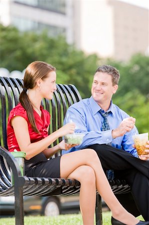 Man and woman sitting on a park bench and eating lunch together Stock Photo - Budget Royalty-Free & Subscription, Code: 400-04133501