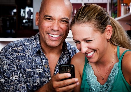 portraits of beautiful bald shaved women - Attractive couple in a coffee house with cell phone Stock Photo - Budget Royalty-Free & Subscription, Code: 400-04133964