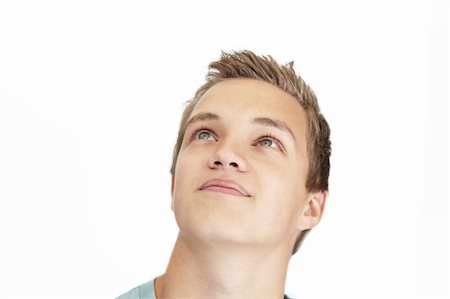 A daydreaming young man on a white background Stock Photo - Budget Royalty-Free & Subscription, Code: 400-04144547