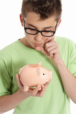 simsearch:400-05248280,k - A boy holding a money box is thinking or pondering, eg finance, savings, spending. Foto de stock - Super Valor sin royalties y Suscripción, Código: 400-04146926