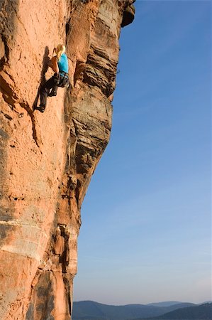 Young woman climbing a rock of sandstone Stock Photo - Budget Royalty-Free & Subscription, Code: 400-04147045