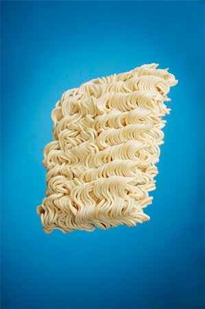 A Block of dried instant ramen noodles on blue background Stock Photo - Budget Royalty-Free & Subscription, Code: 400-04147720