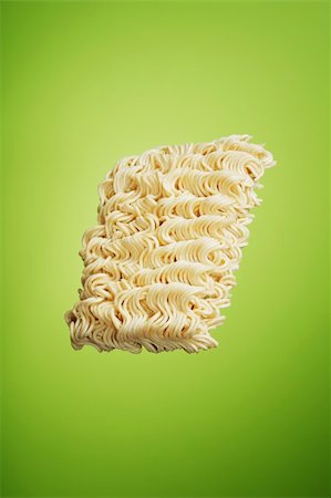 A block of dry instant ramen noodles on green background Stock Photo - Budget Royalty-Free & Subscription, Code: 400-04147721