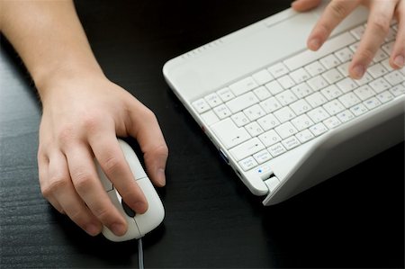 Using a laptop (shallow DOF, right hand is in focus) Stock Photo - Budget Royalty-Free & Subscription, Code: 400-04148098