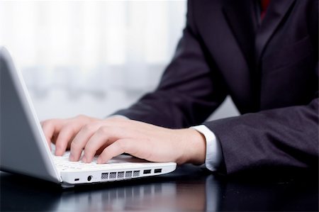 Businessman typing on a notebook (shallow DOF, hand in focus) Stock Photo - Budget Royalty-Free & Subscription, Code: 400-04148103
