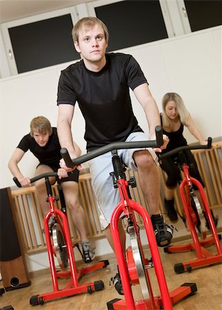simsearch:400-04149259,k - Group of people having spinning class with a young man in focus Stock Photo - Budget Royalty-Free & Subscription, Code: 400-04149255