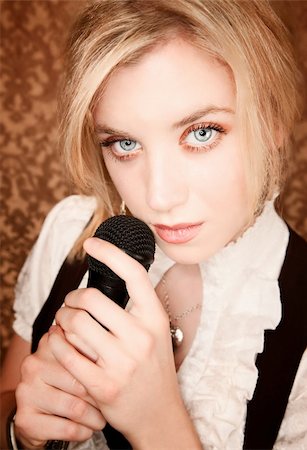 simsearch:400-04655366,k - Pretty blonde woman with a black microphone Stock Photo - Budget Royalty-Free & Subscription, Code: 400-04149348